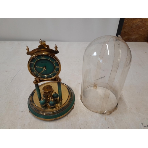 302 - 20th century perpetual clock in glass dome by Kundo