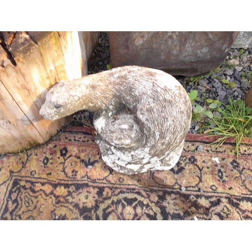 22 - Late 19th century stone pestle, vintage petrol can, composite stone otter
