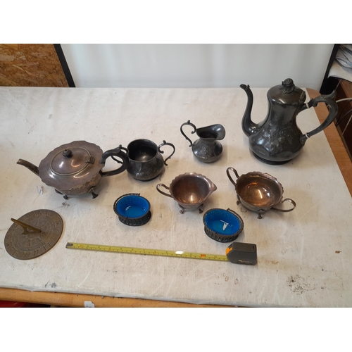 34 - Silver and pewter part tea sets, small brass sundial top