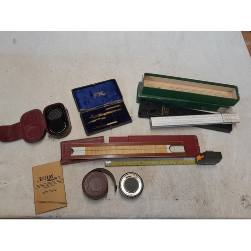 121 - 2 x slide rules, camera light meters etc.