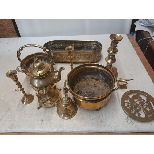 138 - Assorted brassware : candle sticks, bell, tea kettle on stand, Regency style jardiniere etc.