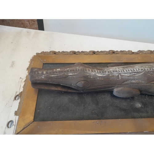 235 - Early 20th century Sepik river carved wooden crocodile mounted on a spurious piece of board in a gil... 