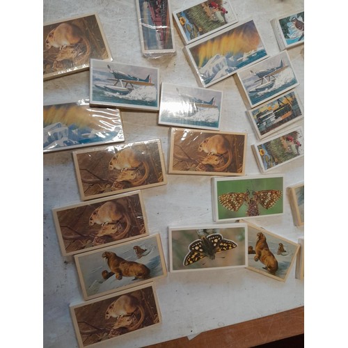 48 - Assorted differing sized format trade, cigarette and tea cards mainly in sealed packets