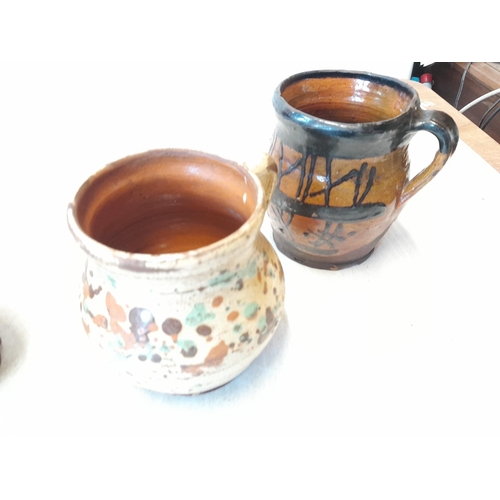 82 - 4 x pre 1900 slip glaze decorated earthenware mugs