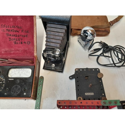 108 - Box of oddments : Kodak bellows camera, Meccano motor, bakelite camera, plated ware, Avo meter, Moor... 