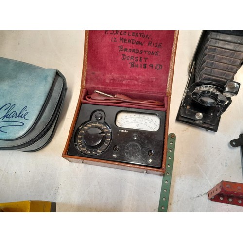 108 - Box of oddments : Kodak bellows camera, Meccano motor, bakelite camera, plated ware, Avo meter, Moor... 