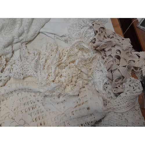 214 - Box of vintage textiles : linen and crochet edging, table covers, bedspreads etc.