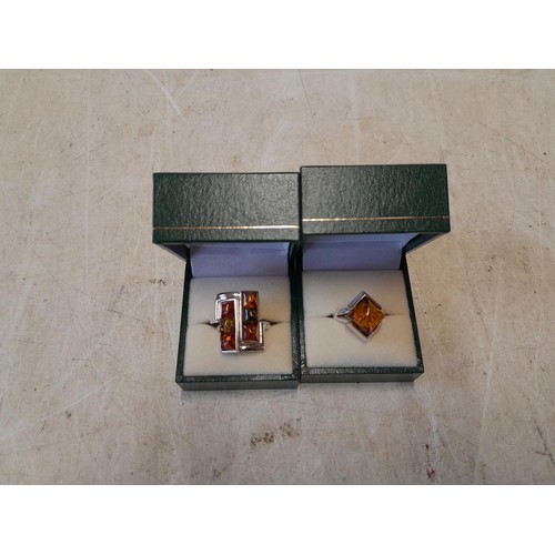 169 - 2 x silver and amber rings in presentation boxes size K & Double ring Q