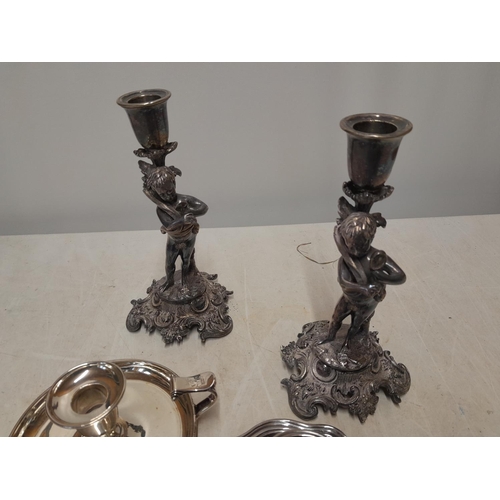 203 - Pair of silver plated cherub candlesticks, 2 x chamber sticks etc.