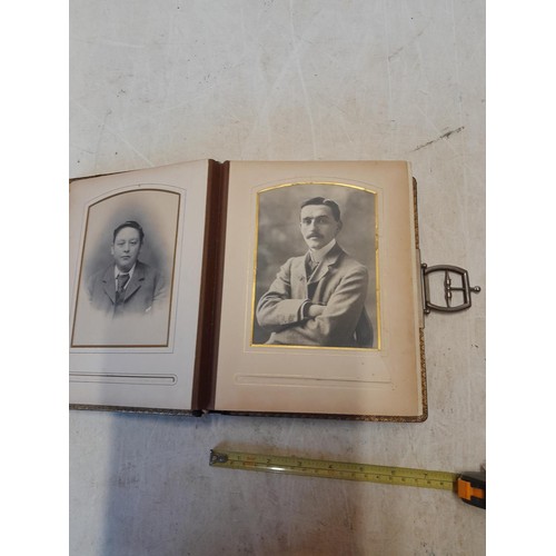 222 - A well filled early 20th century family photograph album, note spine damage