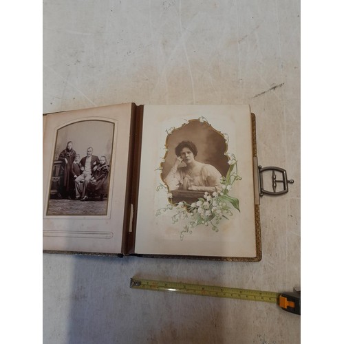 222 - A well filled early 20th century family photograph album, note spine damage