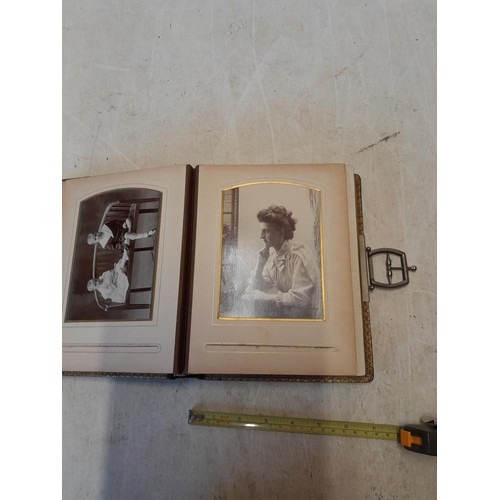 222 - A well filled early 20th century family photograph album, note spine damage