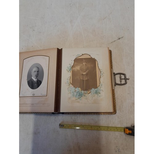 222 - A well filled early 20th century family photograph album, note spine damage