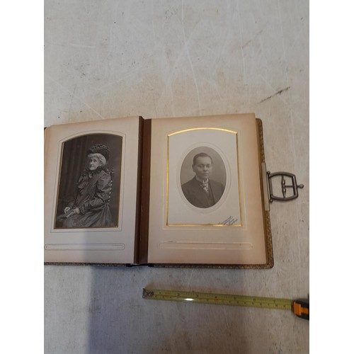 222 - A well filled early 20th century family photograph album, note spine damage