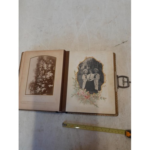 222 - A well filled early 20th century family photograph album, note spine damage