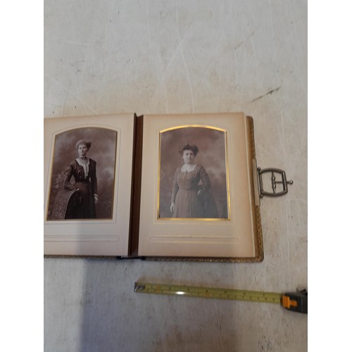 222 - A well filled early 20th century family photograph album, note spine damage