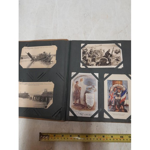 574 - An album of black and white military interest postcards, World War I and War II interest