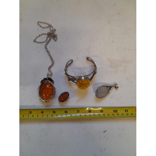 52 - Assorted silver and reconstituted amber jewellery including large revolving pendant, bangle etc.