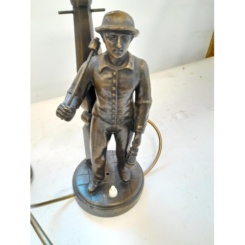 58 - Metal table lamp modelled as a miner next to street lamp