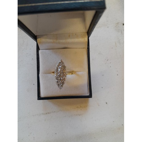 42 - Unmarked but tested 18 ct gold ring oval set with approx 20 diamonds of varying size , size N, 3.6 g