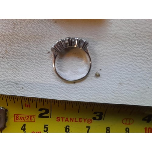 43 - Good quality unmarked but tested 18 ct gold and platinum ring set with five graduated diamonds size ... 