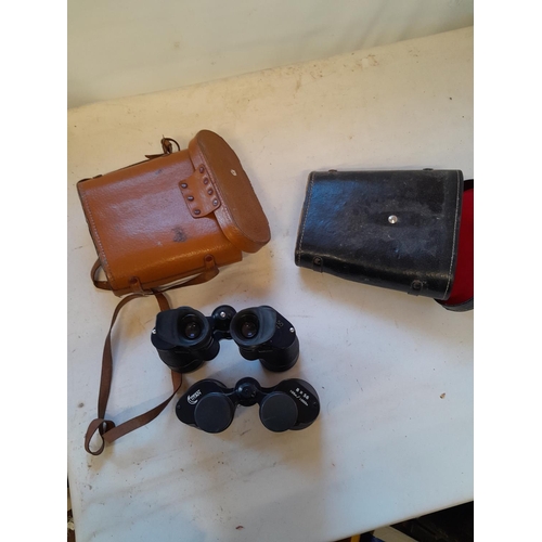 136 - 2 pairs of binoculars in leather cases : Raiya 7 x 50 & 1 x Titan 8 x 56