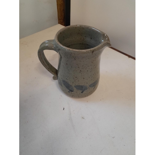 255 - Studio pottery jug, fritting on bottom edge