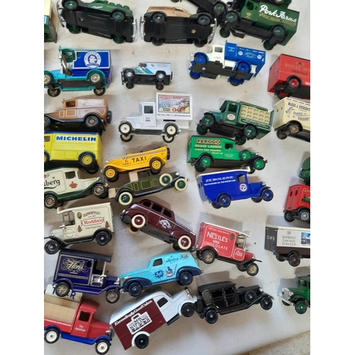 235 - Large array of unboxed die cast toy cars, advertising Lledo, and others, with some loose empty boxes