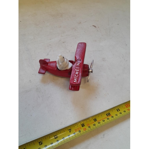 388 - Cast iron Michelin Man in aeroplane