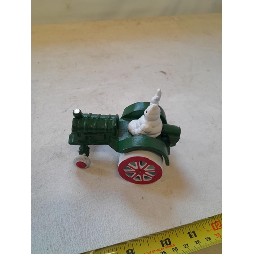 389 - Cast iron Michelin man in tractor