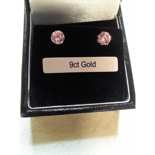 59 - Pair of 9 ct gold earrings set with pink stones in presentation box