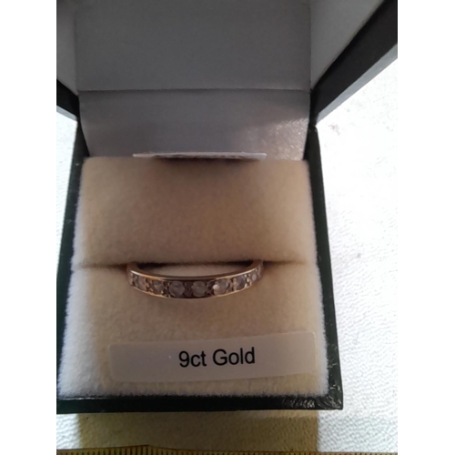 60 - 9 ct gold semi eternity ring set with paste size Q 1.5  g in presentation box