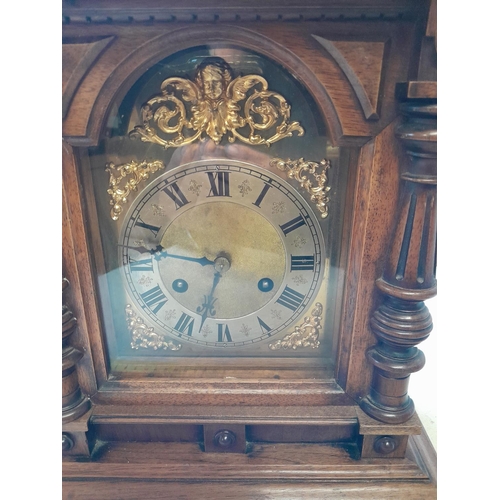 288 - Early 20th century mantle clock with arched dial with pendulum and key