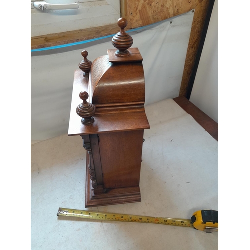 288 - Early 20th century mantle clock with arched dial with pendulum and key