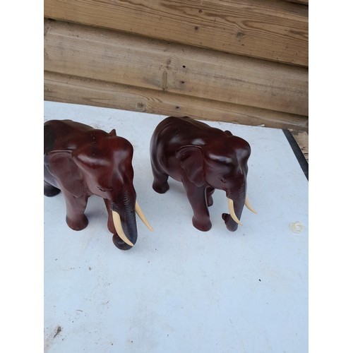 76 - Pair of vintage carved Rosewood elephants with painted tusks 21 cms x 16 cms