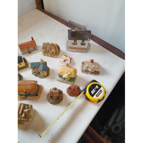 13 - Various resin, plaster and pottery cottage ornaments, (David Winter interest) in various states of r... 