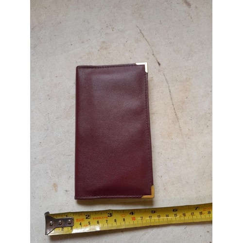 142 - Dunhill notebook in maroon leather case with original page marker