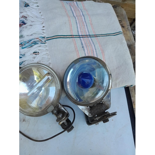 187 - Vintage car headlamps, 2 x metal cased & 2 x plastic with vintage cotton bedspread