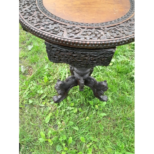 241 - 19th century Burmese rosewood profusely carved table on single pedestal with four drawers