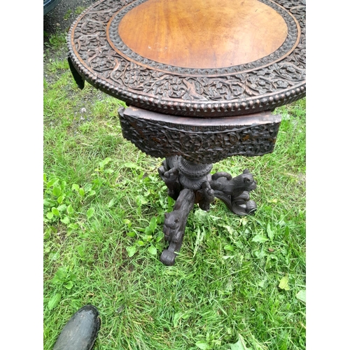 241 - 19th century Burmese rosewood profusely carved table on single pedestal with four drawers