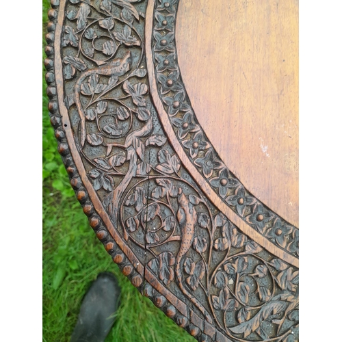 241 - 19th century Burmese rosewood profusely carved table on single pedestal with four drawers