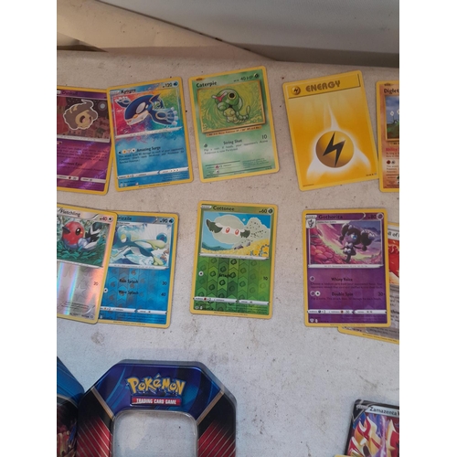 143 - Pokemon trading cards and tins