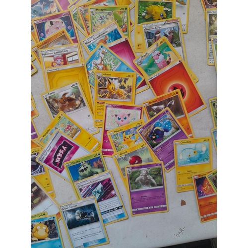 144 - Pokemon trading cards and tins