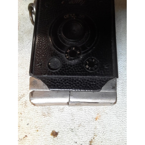 436 - Vintage Mugette camera pocket petrol lighter, note damage