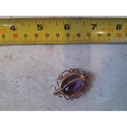 14 - Unmarked 9 ct gold mounted brooch set with amethyst