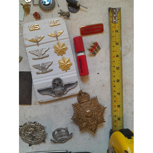 45 - Array of military interest cap badges, advertising penknife, pince nez etc.