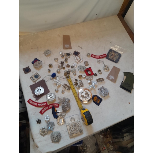 51 - Assorted military issue cap, lapel badges buckles and related items