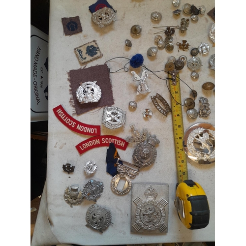 51 - Assorted military issue cap, lapel badges buckles and related items