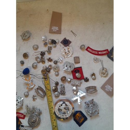 51 - Assorted military issue cap, lapel badges buckles and related items