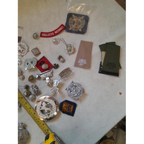 51 - Assorted military issue cap, lapel badges buckles and related items